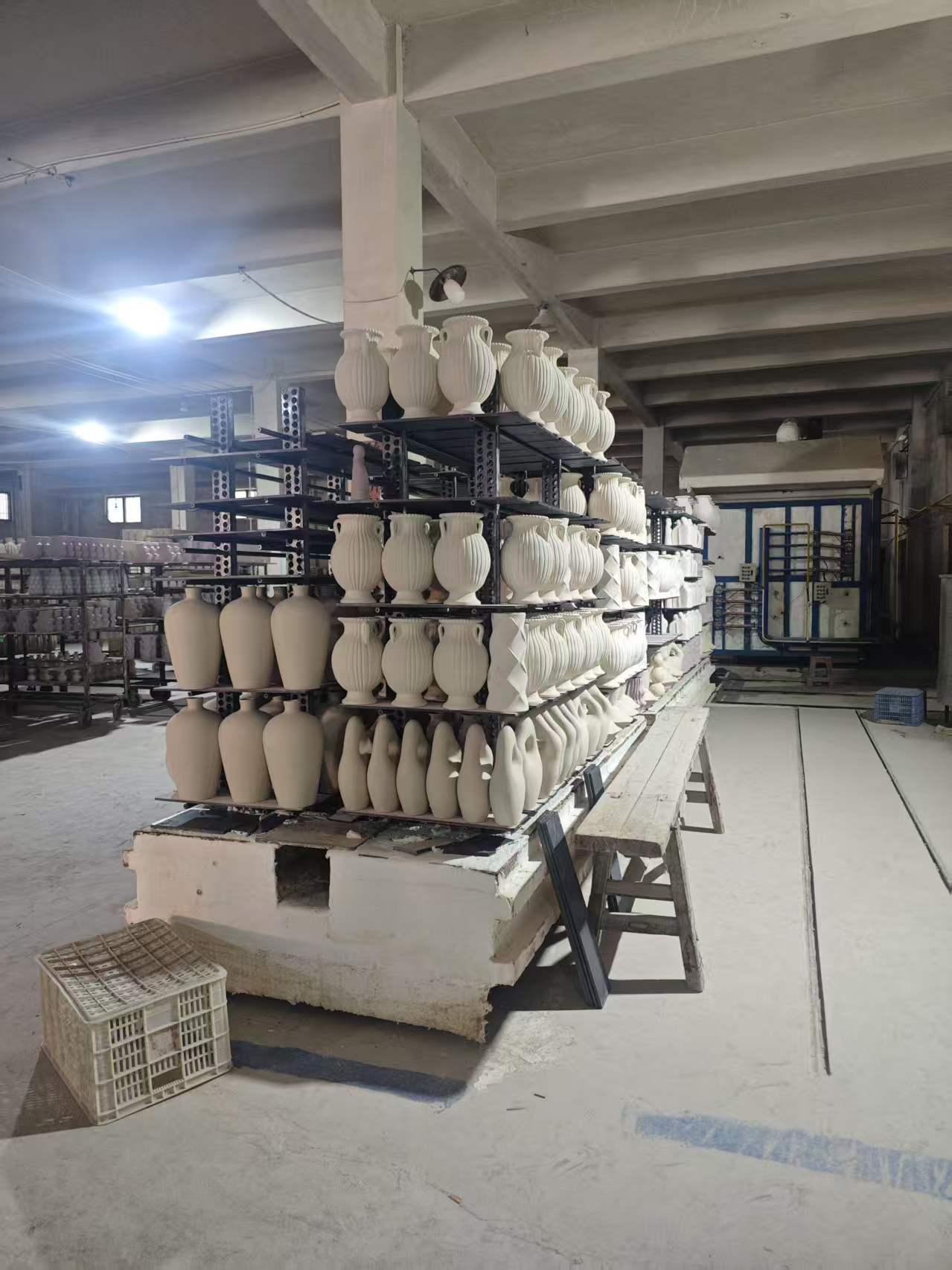 In-stock ceramic vessels staged on factory racks in Chaozhou